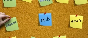 Bulletin board with sticky notes with words such as: knowledge, ability, competence, skills, and goals.