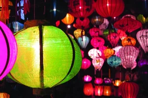 Dozens of colorful Asian lanterns lit up in the dark.